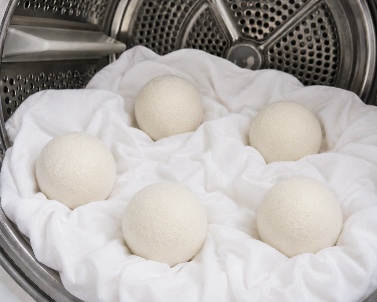 CozyLife wool dryer balls inside a washing machine drum.