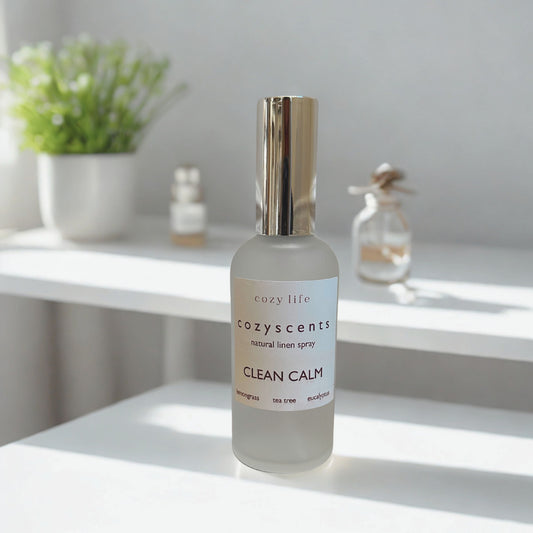 Cozy Scents 'Clean Calm' serum bottle on a white surface with a blurred background.