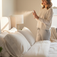 Women spraying Citrus Zen CozyLife Natural Linen Spray on to pillows.